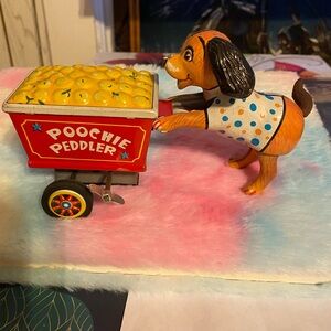 VINTAGE POOCHIE PEDDLER WINDUP TOY